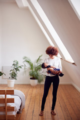 Wall Mural - Loving Mother Holding Newborn Baby At Home In Loft Apartment