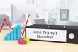ABA Transit Number - Finance/Economy. Folder on desk with label beside diagrams. Business
