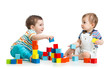 © Oksana Kuzmina - Two babies building block towers. Isolated on white background