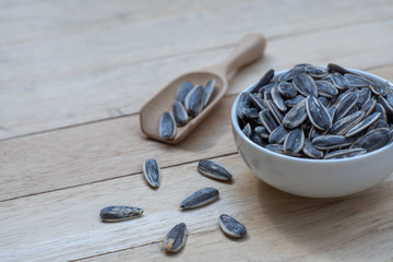 Poster - Sunflower seed, snack, in wooden bowl on wood table