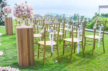 Wall Mural - Wedding ceremony. Arch, decorated with flowers on the lawn, beach background, sea in summer.