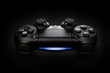 © B@rmaley - Closeup photo of video game console gamepad joystick controller on black background with blue light.