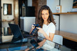 © F8  \ Suport Ukraine - Freelance photographer woman with camera at home office editing photos on laptop