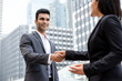 © Atstock Productions - Smiing handsome young Indian businessman making handshake with businesswoman
