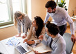 © Zoran Zeremski - Group of young business people working together while sitting at the office desk.