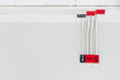 White electric PVC pipe in red and black are connected to power lines or electrical wires, Ethernet UTP cables, internet and light boxes on building wall. Concept for construction and system building.