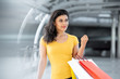 © Atstock Productions - Smiling beautiful woman carrying colorful shopping bags