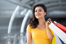 Smiling Beautiful Woman Carrying Colorful Shopping Bags