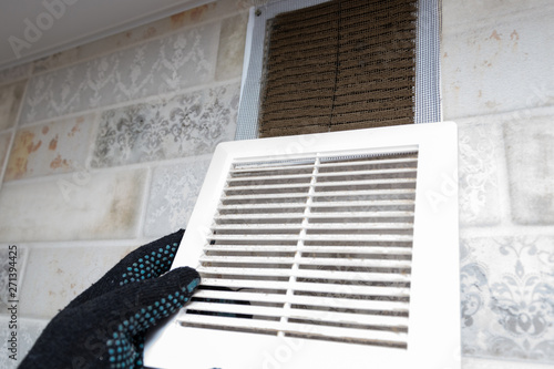 Repair Service Man Removing A Dirty Air Filter On A House So