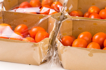 ripe cherry tomatoes packages in box and plastic