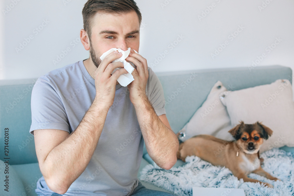 Man suffering from pet allergy at home