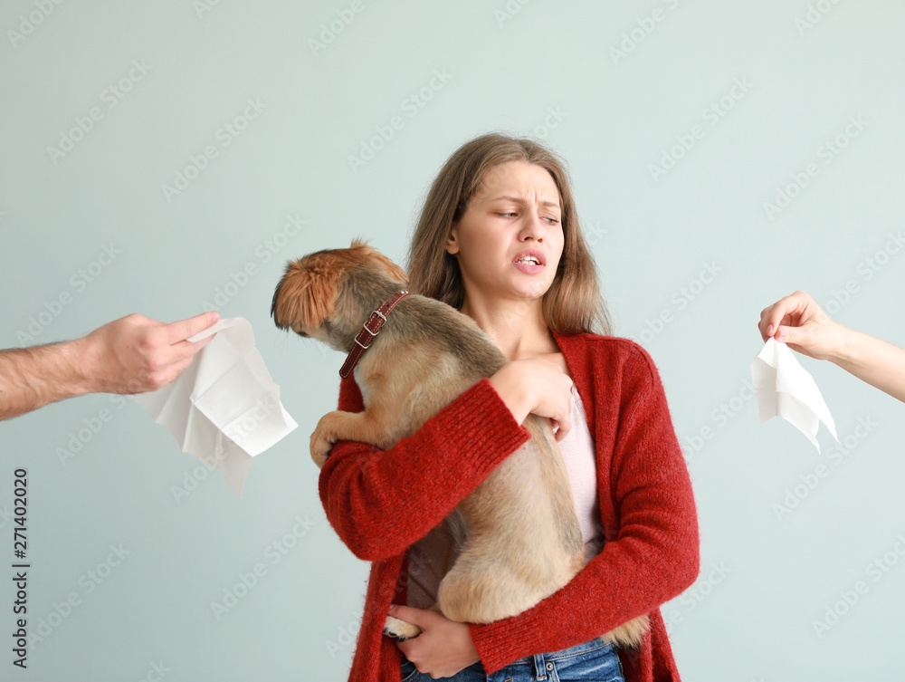 Woman suffering from pet allergy on light background