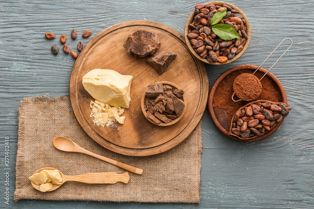 Different cocoa products on wooden background