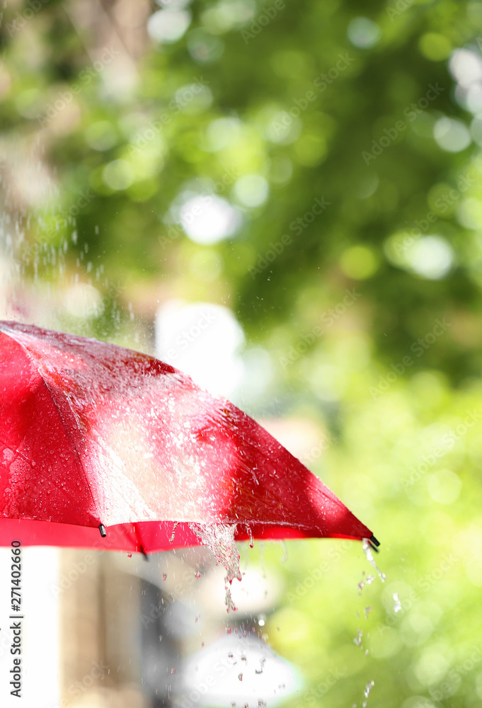 Red umbrella outdoors on rainy day