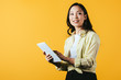 © LIGHTFIELD STUDIOS - smiling asian girl using digital tablet, isolated on yellow