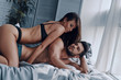 © gstockstudio - Passionate love. Beautiful young semi-dressed couple about to make love while spending time in the bed