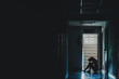 © TeTe Song - Silhouette of girl sitting alone in the dark,Sad and Serious women sitting hug his knee alone of old condo, Domestic violence, family problems, Stress, violence, with copy space