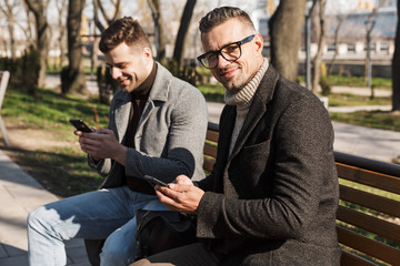 Canvas Print - Two handsome men wearing coats spending time