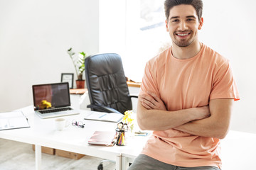 Wall Mural - Happy handsome man in casual clothes looking at the camera