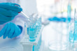 © freebird7977 - Scientists analyzing study data and evaluating microscope.  Health care researchers doing some research with dropper chemical testing and working in life science laboratory.
