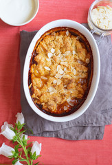 Wall Mural - Overhead image of plum cobbler with almond flakes and cream