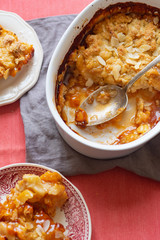 Wall Mural - Overhead image of plum cobbler with almond flakes and cream