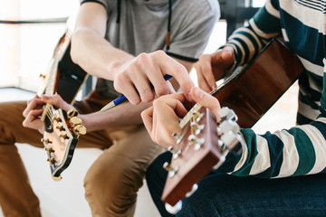 Learning to play the guitar. Extracurricular activities or tutoring or hobbies or creative activities.