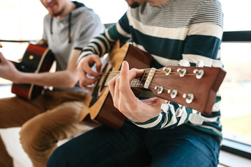 Wall Mural - Learning to play the guitar. Extracurricular activities or tutoring or hobbies or creative activities.