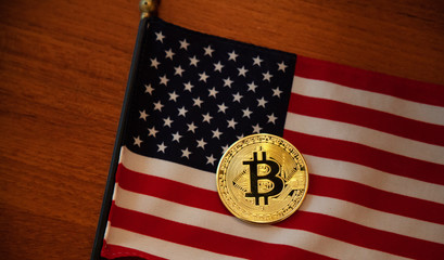 Bitcoin and american flag, closeup.