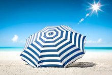 Summer Background Of Umbrella With Free Space For Your Decoration On Hot Sand. Sunny Day And Ocean Landscape. 