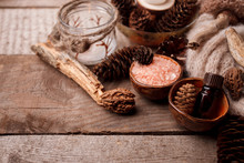 Wood Scents For Winter Time Aromatherapy. Pine Cones, Candles, Essential Oil Bottles, Top View. Spa Relax Winter Concept, Copy Space
