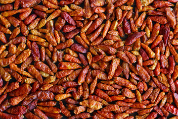 Dried bird's eye chili peppers on a dark wooden table. Wallpaper, high resolution