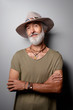 © luengo_ua - Style and vacation concept. Studio portrait of handsome senior man with gray beard and hat.