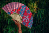 Fototapeta Bambus - Woman Holding a Japanese Paper Fan