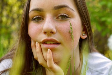 Close up portrait of a teenage girl modelling in the spring flowers