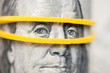 Benjamin Franklin's look on a hundred dollar bill highlighted with gum