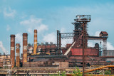 Metallurgical factory with chimneys and smog. Industrial plant for steelworks, ironworks or metalworks as heavy industry background