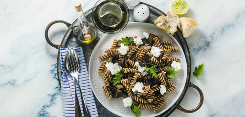 Wall Mural - banner of gluten-free pasta from half-wheat farro flour with portobello mushrooms and ricotta cheese on a tray on a marble table. healthy vegetarian recipes