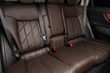 Wall Mural - Сlose-up of the car   interior: brown natural leather rear seats and seat belts .