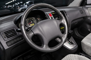 Wall Mural - Close-up of the dashboard, speedometer, tachometer and steering wheel. Luxurious car interior details.