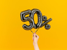 Fifty Percent Symbol Discount. 50 % Sale Banner Black Flying Foil Balloons On Yellow. 3d Rendering.