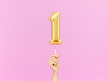 One Year Birthday. Female Hand Holding Number 1 Foil Balloon. One-year Anniversary Background. 3d Rendering