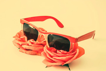 coral colored sunglasses and flowers