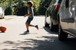 © Photographee.eu - Careless boy running behind the ball on the road next to cars