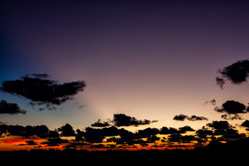 Wall Mural - Clouds silhouetted at dusk in Japan