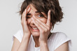 © Drobot Dean - Beautiful young pretty scared woman posing isolated over white wall background.