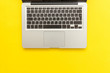 © Юлия Завалишина - Keyboard laptop computer isolated on yellow desk background. Modern Information technology and sofware advances. Freelance home office programmer or designer workspace concept