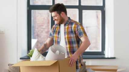 Sticker - moving, people and real estate concept - happy man with box at new home