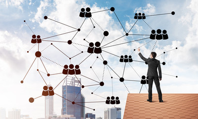 businessman on house roof presenting networking and connection concept. mixed media