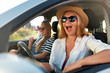 © artiemedvedev - Two young cheerful smiling women in a car on vacation trip to the sea beach. Girl in glasses driving a vehicle from rental on holidays. Girlfriends enjoying summer arrived to ocean shore on holidays.